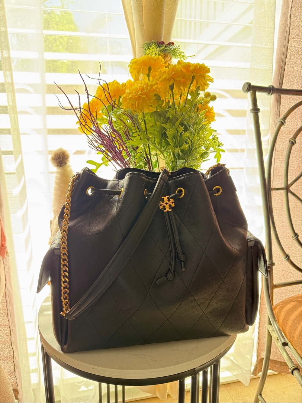 Black Quilted Drawstring Shoulder Bag with Gold Accents
